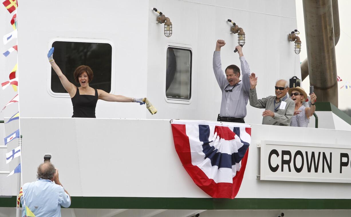 Nancy Curcio, left, celebrates Saturday immediately after christening Crown Point -- the newest towboat of Tidewater Transportation and Terminals -- at Vancouver's Terminal 1 along the Columbia River.