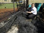 Deputy Fire Marshal Zane Norris investigates a fire near a dumpsters at an apartment complex.