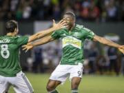 Timbers' forward Fanendo Adi, right, celebrates after scoring the first goal of the game with Diego Valeri, who assisted in the goal, during the second half at the Portland Timbers' match against the Chicago Fire on Friday Aug. 7, 2015, at Providence Park.