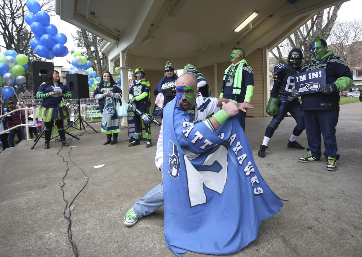 Fans of the Seattle Seahawks gather Saturday in Esther Short Park for a 12th man rally in advance of Sunday's Super Bowl game against the New England Patriots. Top: Travis Trombley shows his Seahawks spirit through his hairstyle at a rally in downtown Vancouver.