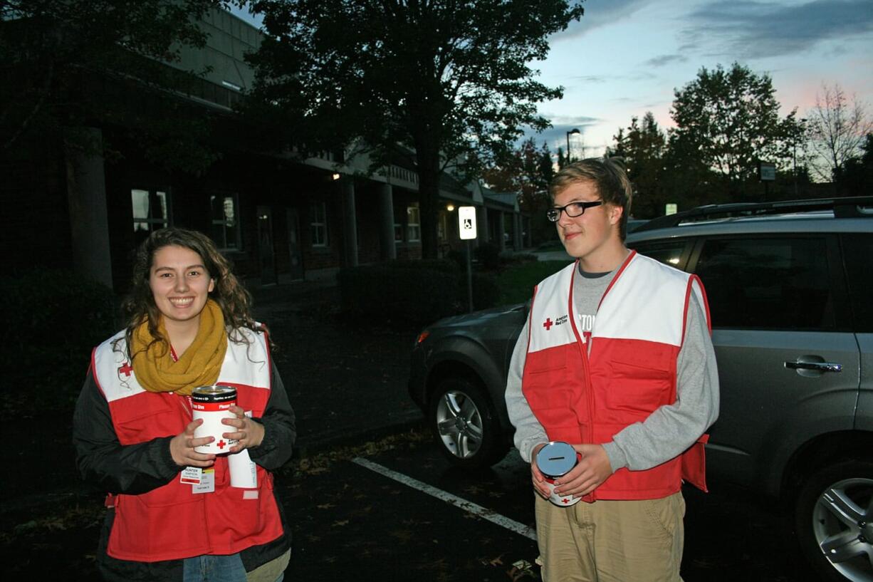 Clark County: Hudson's Bay High School seniors and Red Cross Youth Club members Hunter Simpson, left, and Jase Murphy prepare to &quot;Trick-or-Treat for Disaster.&quot; About 160 high-schoolers from Clark County collected donations from residents on Halloween instead of candy.