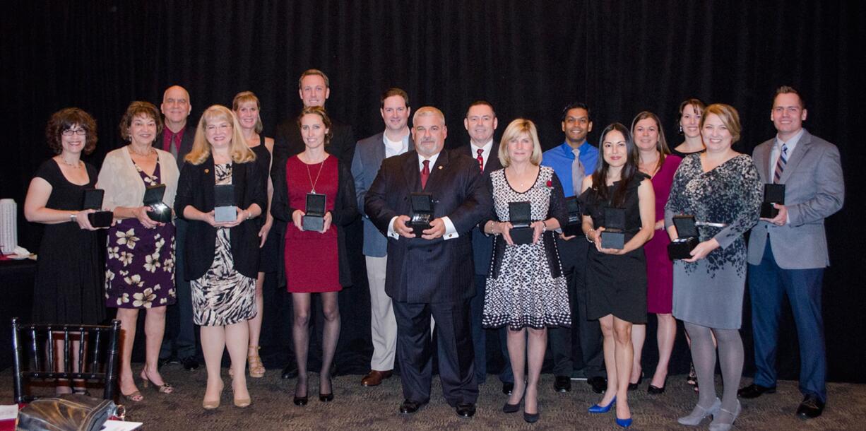 Salmon Creek: Former Washington State University Vancouver students hold the 2014 Notable Alumni Honors they received at the university's 25th anniversary celebration dinner on Nov.