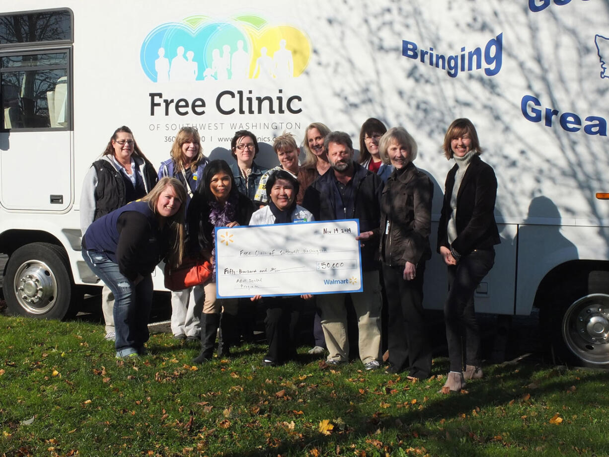 Bagley Downs: Wal-Mart employees stand with Free Clinic of Southwest Washington staff during Wal-Mart Day at the Free Clinic on Nov.