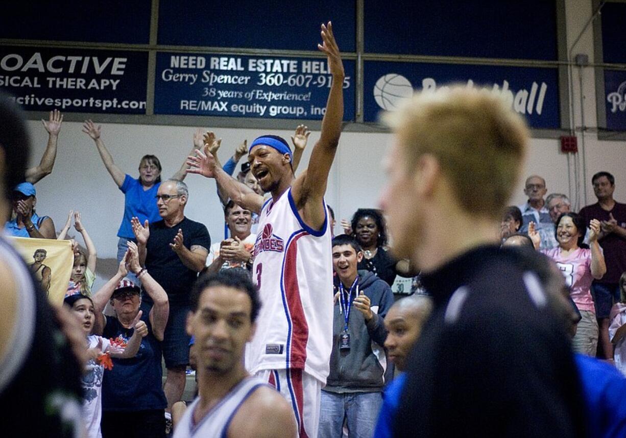 Volcanoes forward Kevin Bloodsaw celebrates in the stands after winning the IBL championship game against the Edmonton Energy 124-116 at the O'Connell Sports Center at Clark College on Sunday.