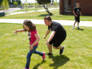 Ridgefield: Carter Allen, a junior at Ridgefield High School, plays tag with the students at the school's field day, which Ridgefield's leadership class organized for 90-plus special education and life skills students from other schools.