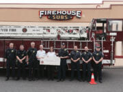 Vancouver Mall: Representatives from the Vancouver Fire Department Fire Marshal's Office accept a $13,000 grant for new tablets from the Firehouse Subs Public Safety Foundation.