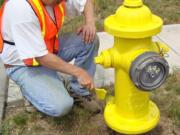 Battle Ground: Battle Ground City Council member Bill Ganley paints a fire hydrant, just as he's done with about 1,500 other hydrants in the past 12 years. He was recognized for his volunteer efforts at an Oct.