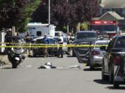 Detectives investigate a shooting of a Vancouver police officer Monday in east Vancouver.