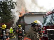 Firefighters try to contain an apartment fire at the Rolling Creek Apartments in Hazel Dell Thursday afternoon.