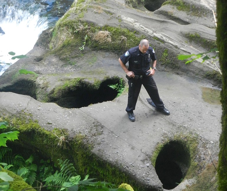 A police officer surveys an area known as the Potholes in Camas in 2015.