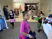 Photos by Amanda Cowan/The Columbian
Ryileigh Jones, 6, looks to her mother for approval while choosing clothing at the Go Ready Festival on Wednesday at Hudson's Bay High School. The festival provides immunizations, haircuts, clothing, shoes -- and ice cream -- to Vancouver students in need.