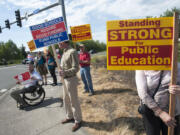 Teachers from Battle Ground picket at the busy intersection of Main Street and state Highway 503 after school Wednesday.