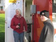 College Burger Manager Liz Batchelor, left, is training Washington State School for the Blind student Jake Ergler at the College Burger food cart at Clark College.