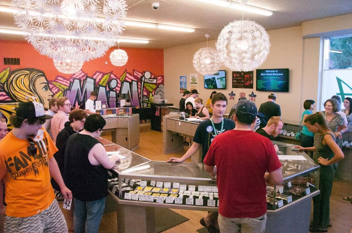 Justin Runquist/The Columbian
Customers visit Main Street Marijuana in Vancouver on Wednesday, the day recreational marijuana became legal in Oregon. Vancouver pot shops have seen an increase in business this week and suspect the change in Oregon's law has something to do with it.