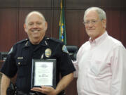 Battle Ground: Clark County Juvenile Court Program Manager Eric Gilman, right, presents the Northwest Justice Forum's 2015 Regional Restorative Justice Award to Battle Ground Police Chief Bob Richardson.