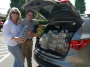 Fruit Valley: Windermere Stellar real estate brokers Barbara Corigliano and Mike Owens deliver food to Fruit Valley Elementary School's food pantry during Windermere's company-wide Community Service Day.