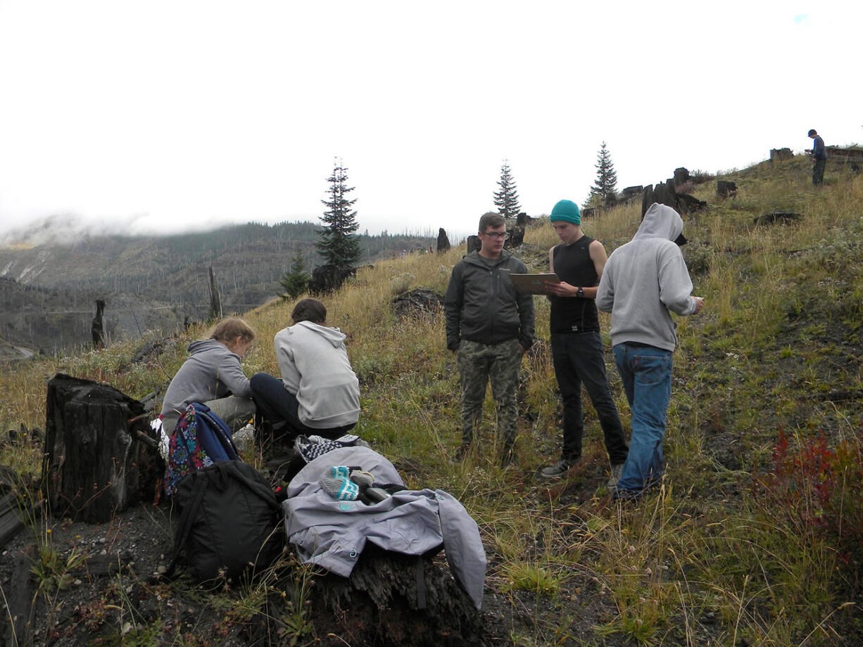 On a hilltop near the Miner's Car site at Mount St. Helens National Volcanic Monument, students from CASEE in Battle Ground prepare to conduct terrestrial sampling of ground cover, canopy and soils.