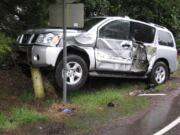 A Nissan SUV ended up atop barricades that protect a fire Hydrant after a two-vehicle collision Wednesday at Northeast 159th Street and Caples Road.