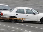 Local police officers practice the precision immobilization technique Friday at the Portland International Raceway.