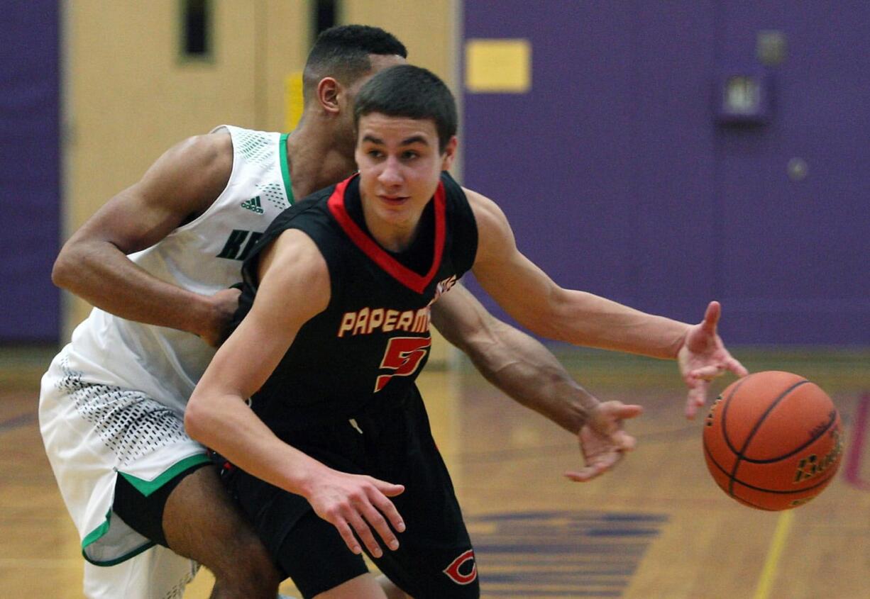 Kentwood's Malik Sanchez, wearing white, knocks the ball from Jordan Anderson (5) of Camas during Saturday's playoff game in Puyallup.