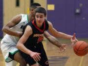 Kentwood's Malik Sanchez, wearing white, knocks the ball from Jordan Anderson (5) of Camas during Saturday's playoff game in Puyallup.