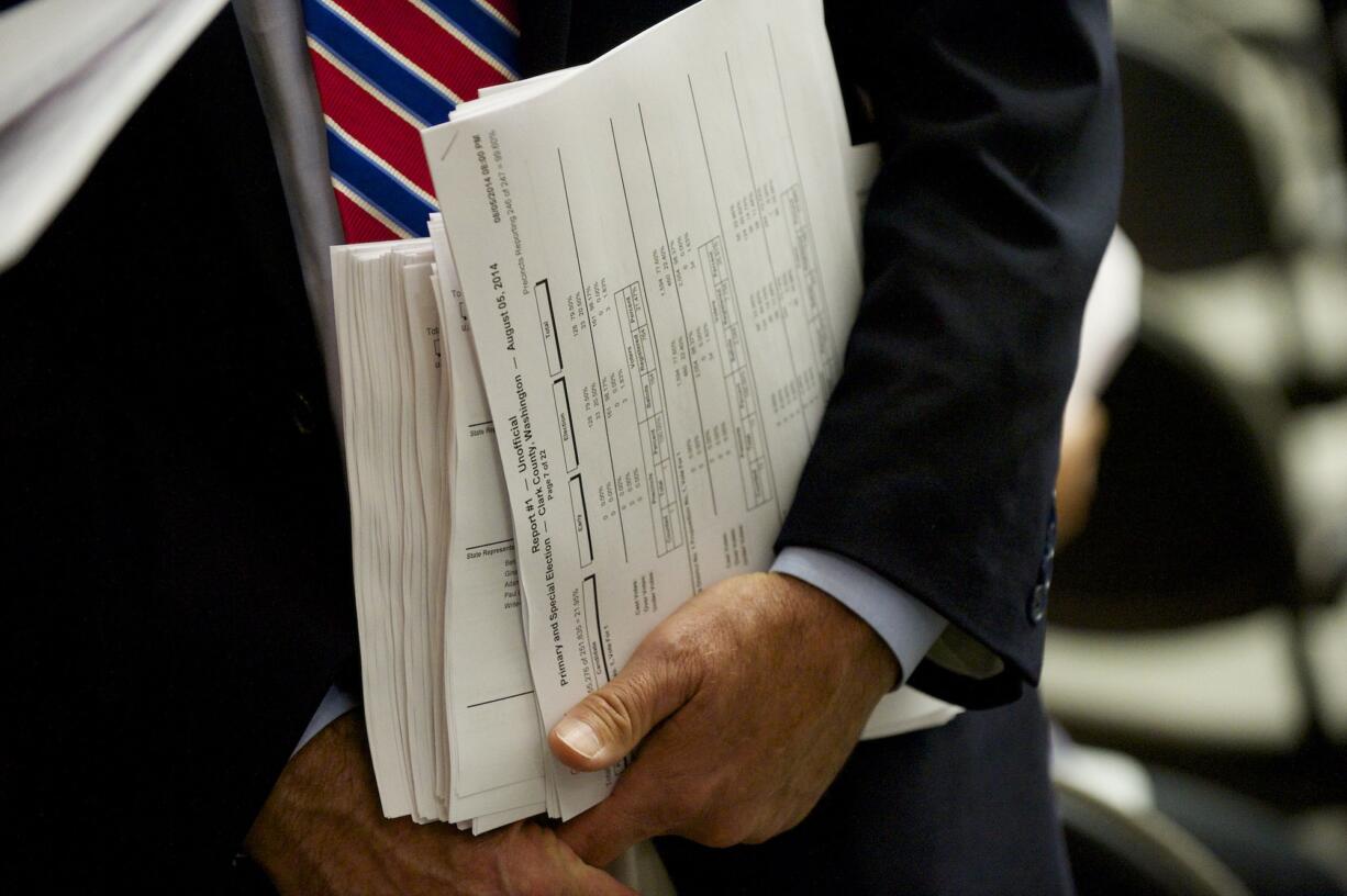 Clark County Auditor Greg Kimsey arrives with primary election results Tuesday at the Clark County Public Service Center in Vancouver.