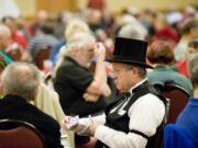 Richard Garvin of Corvallis, Ore., studies his cards Sunday during the Oregon Trail Regional contract bridge tournament at the Hilton Vancouver Washington.