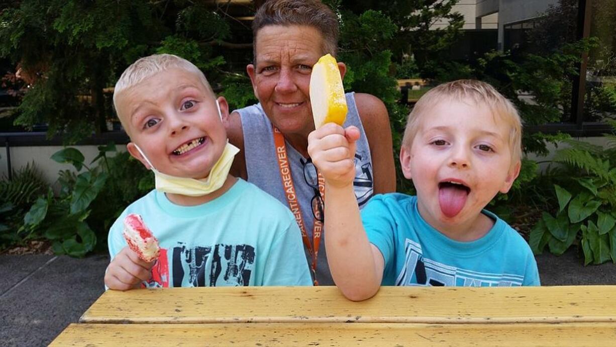 Jack Conover, 7, left, enjoys some ice cream with his grandma Tina Conover and brother, Patrick Anderson, 4, at Seattle Childrenu2019s Hospital. Tina Conover and Patrick were visiting Jack after his June 14 heart transplant.