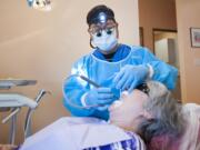 Dentist Steven Quan works on a patient Thursday morning at the new Geriatric Dental Group office in Vancouver.