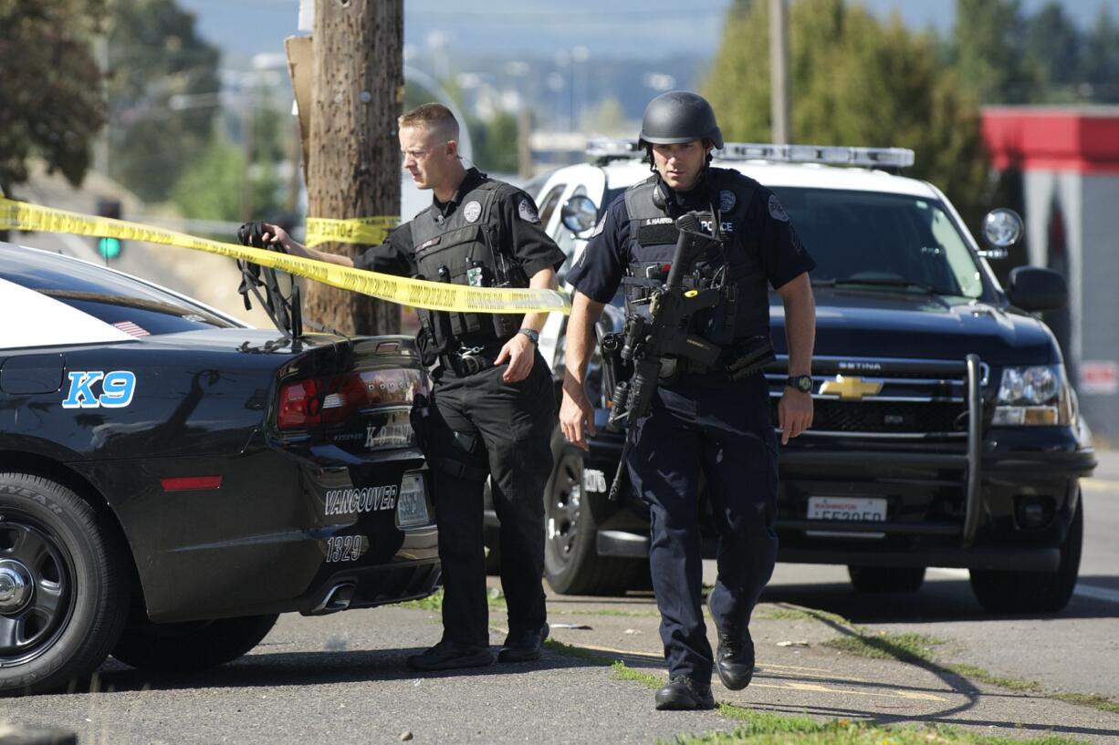 Police search for a homicide suspect near the intersection of Fourth Plain and Kauffman, Thursday, September 25, 2014.