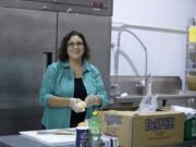 Carmen McKibben peels onions while making pico de gallo at Hour Kitchen on Thursday.