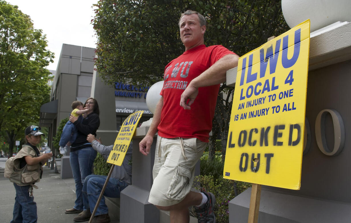 Brian Mitchell of Longview pickets outside the Riverview Bank building in downtown Vancouver, where United Grain has an office.