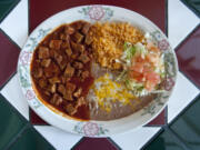 Chile Colorado -- made with cubes of top sirloin in a traditional sauce-- is served with rice and beans at Catedral Tapatia in Vancouver.