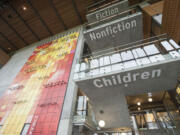 Categories of books are seen printed on the stairwell Tuesday at the public library in Vancouver.