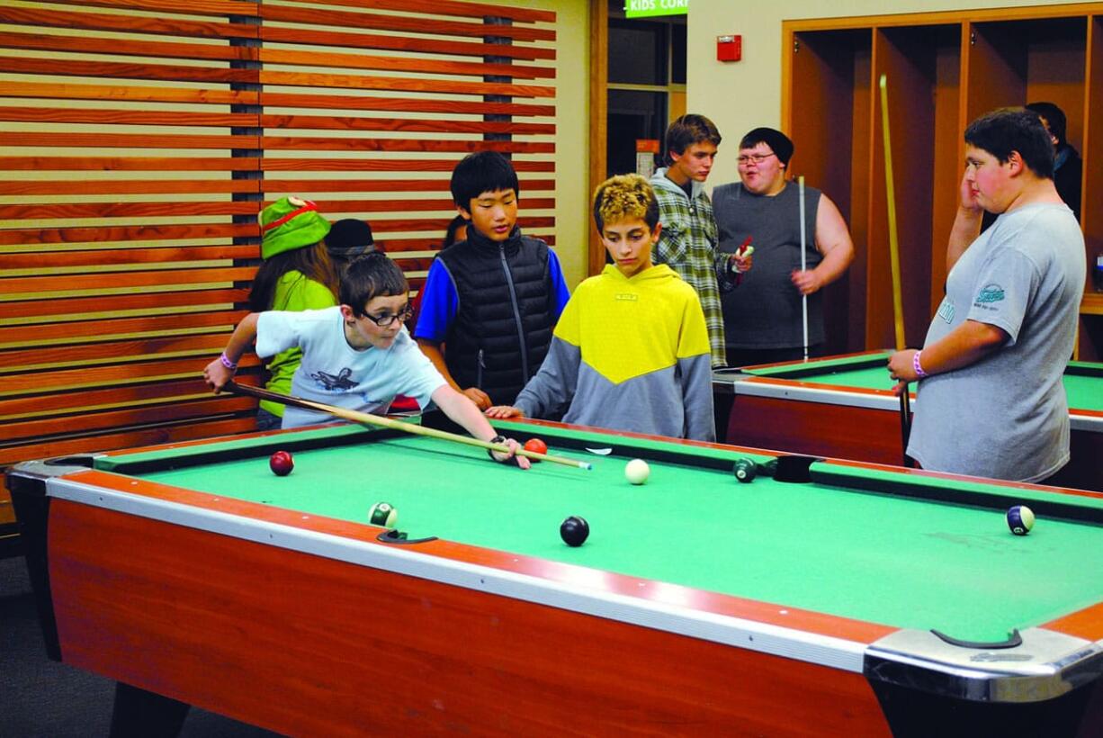 Clark County: Teens play pool at Firstenburg Community Center during a Friday Teen Late Night program event, which was recently supported by a $5,000 grant from Wells Fargo.