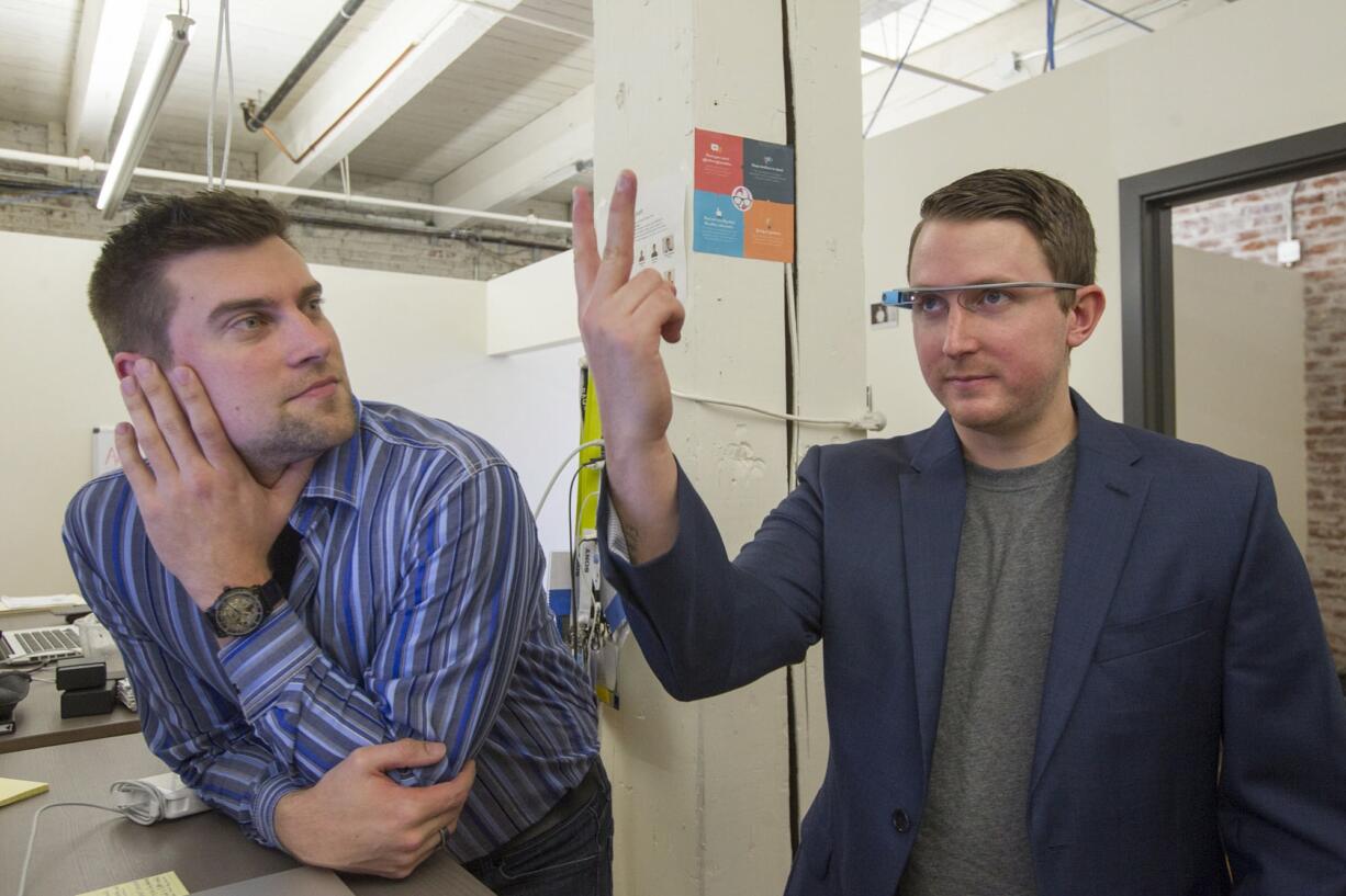 Ty Frackiewicz, left, and Ryan Fink, co-founders of OnTheGo Platforms, demonstrate how to use gesture software called Ari.