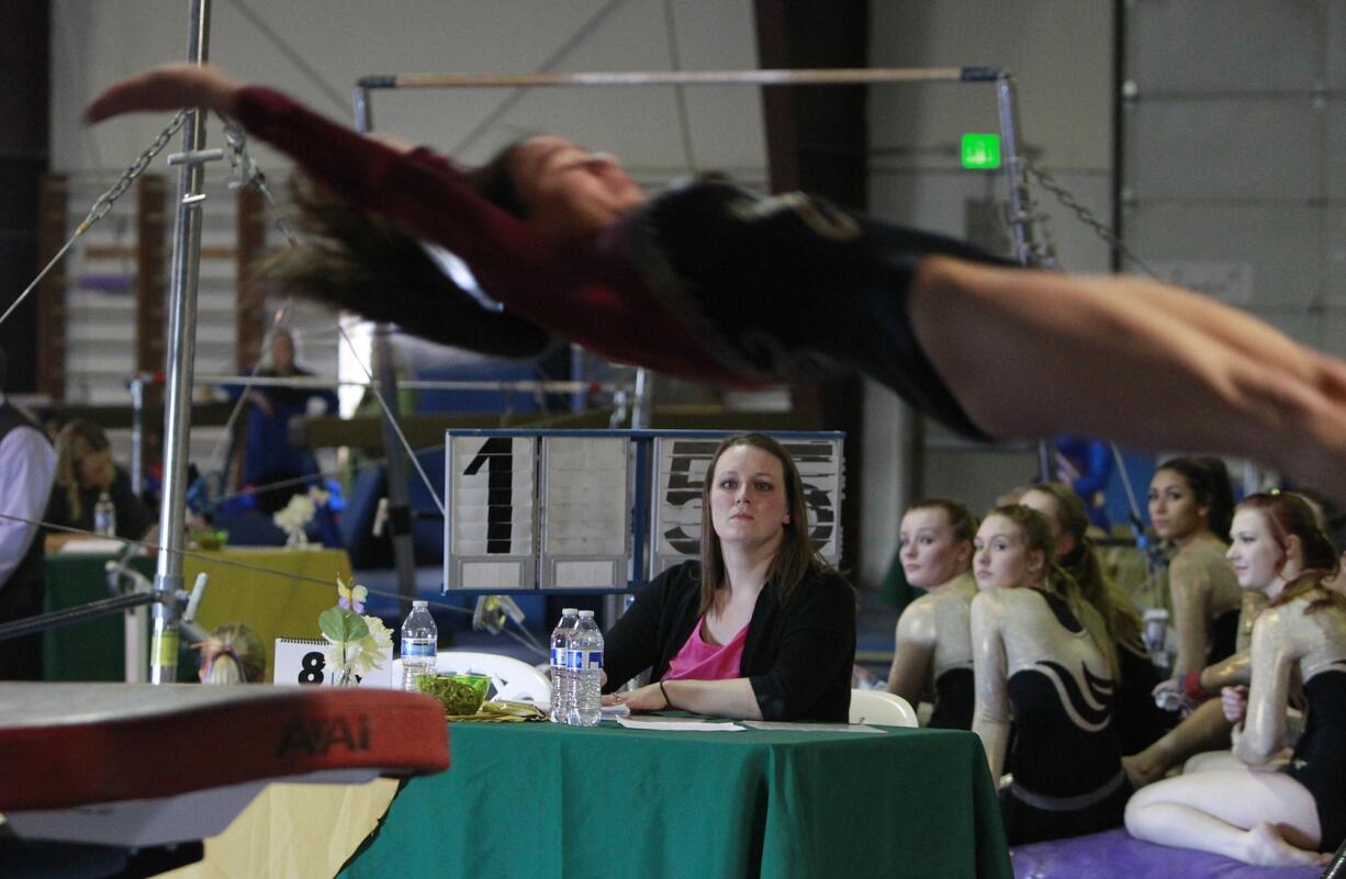 Alicia Green judging a gymnastics meet.