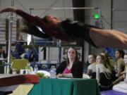 Alicia Green judging a gymnastics meet.