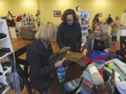 Rosalind Pirkl, from left, Loretta Barber and Laura Harper take part in a class at the Urban Wolves Fibre Arts store in Hazel Dell.