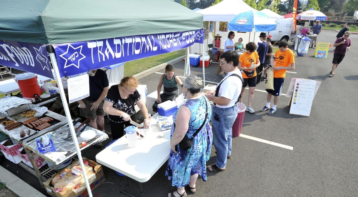 Eileen Granat serves kosher hot dogs at the Bagel On! Fun Fair on Sunday in the Barberton area.