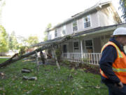 Kirk Ueckert, owner of Timbermans Tree Service, and his crew removed half of a poplar tree that fell on to a northeast Vancouver home Saturday during a wind storm.