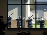 VFW members fire a rifle salute Tuesday rifle during the Veterans Day Celebration at the Armed Forces Reserve Center in east Vancouver.