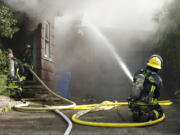 Firefighters battle a blaze Wednesday at 3111 U St.