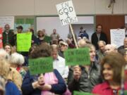 Clark county residents gather in a public hearing room to talk about whether the words  &quot;In God We Trust&quot; should be used in a county public hearing room in Vancouver.