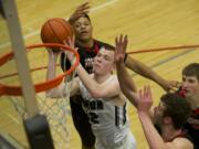 Union's Micah Paulson drives to the basket against Camas.