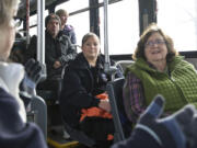 Clark County newcomer Wendy Olmstead, right, receives guidance from C-Tran travel ambassador Virginia Edwards, front left, during a recent trip from Camas to the Westfield Vancouver mall.