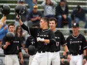 Union's Cody Hawken (16) bumps helmets with teammates after hitting a two run homer in the 1st inning against Kentwood in 4A WIAA State Baseball tournament at Hiedelberg Park in Tacoma on May 23.