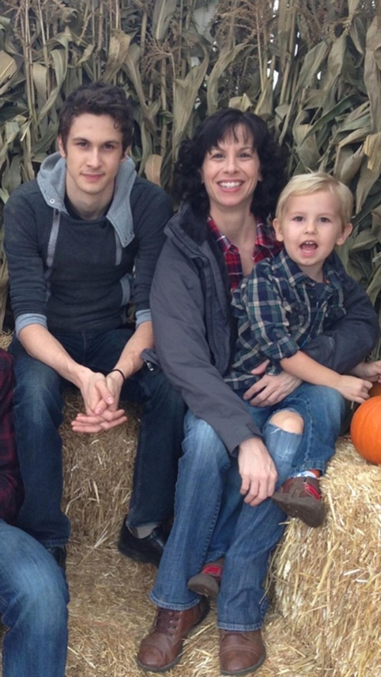 Amy Osborne, center, poses for a picture with her two sons Keenin, left, and Tavyn.