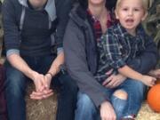 Amy Osborne, center, poses for a picture with her two sons Keenin, left, and Tavyn.