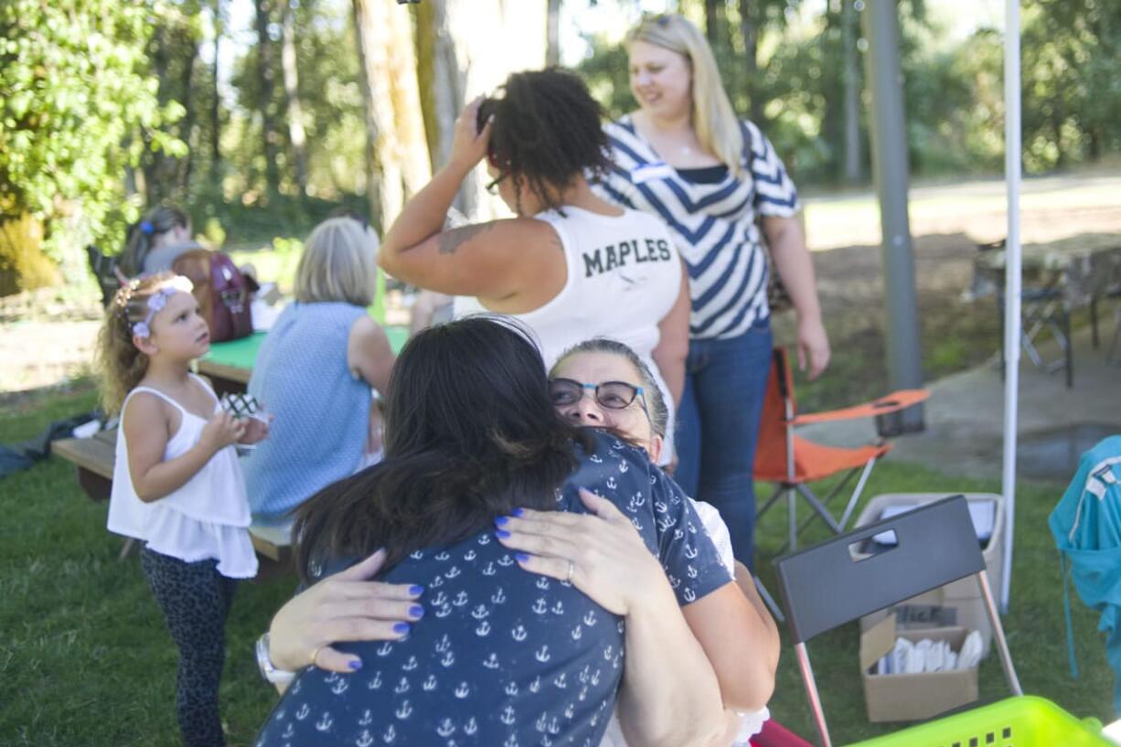 'I Have a Dream' alumni Veronica Beltran, left, hugs program sponsor Leslie Durst during the 20th anniversary picnic of the Southwest Washington 'I Have a Dream' on Friday evening, August 7, 2015 at Marine Park in Vancouver.